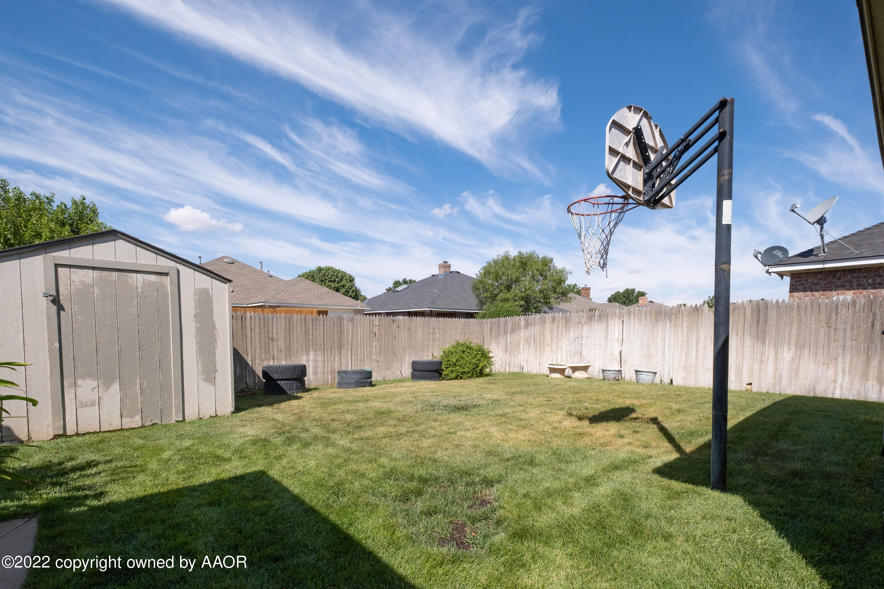 6607 Rally Road Amarillo, TX 79119 - Photo 34 of 34 a backyard of a house with table and chairs