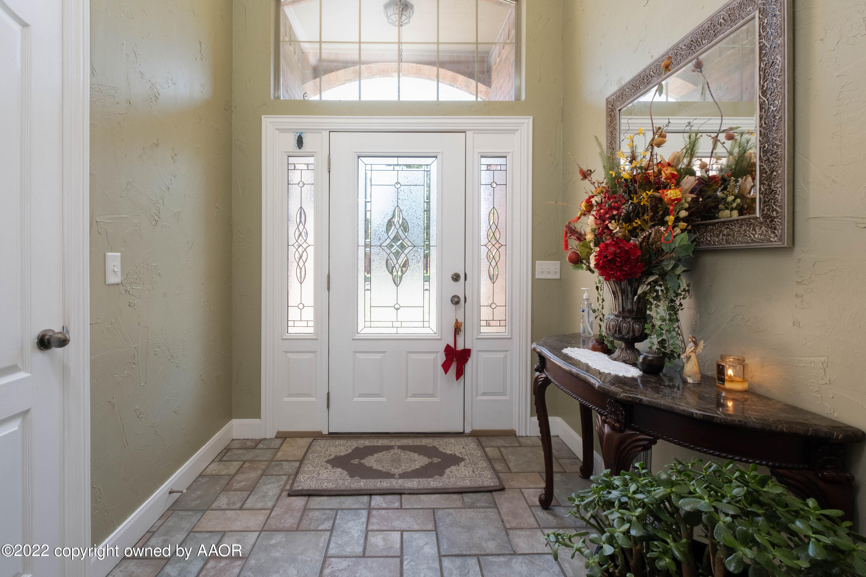 6607 Rally Road Amarillo, TX 79119 - Photo 4 of 34 a view of a hallway with wooden floor and a potted plant