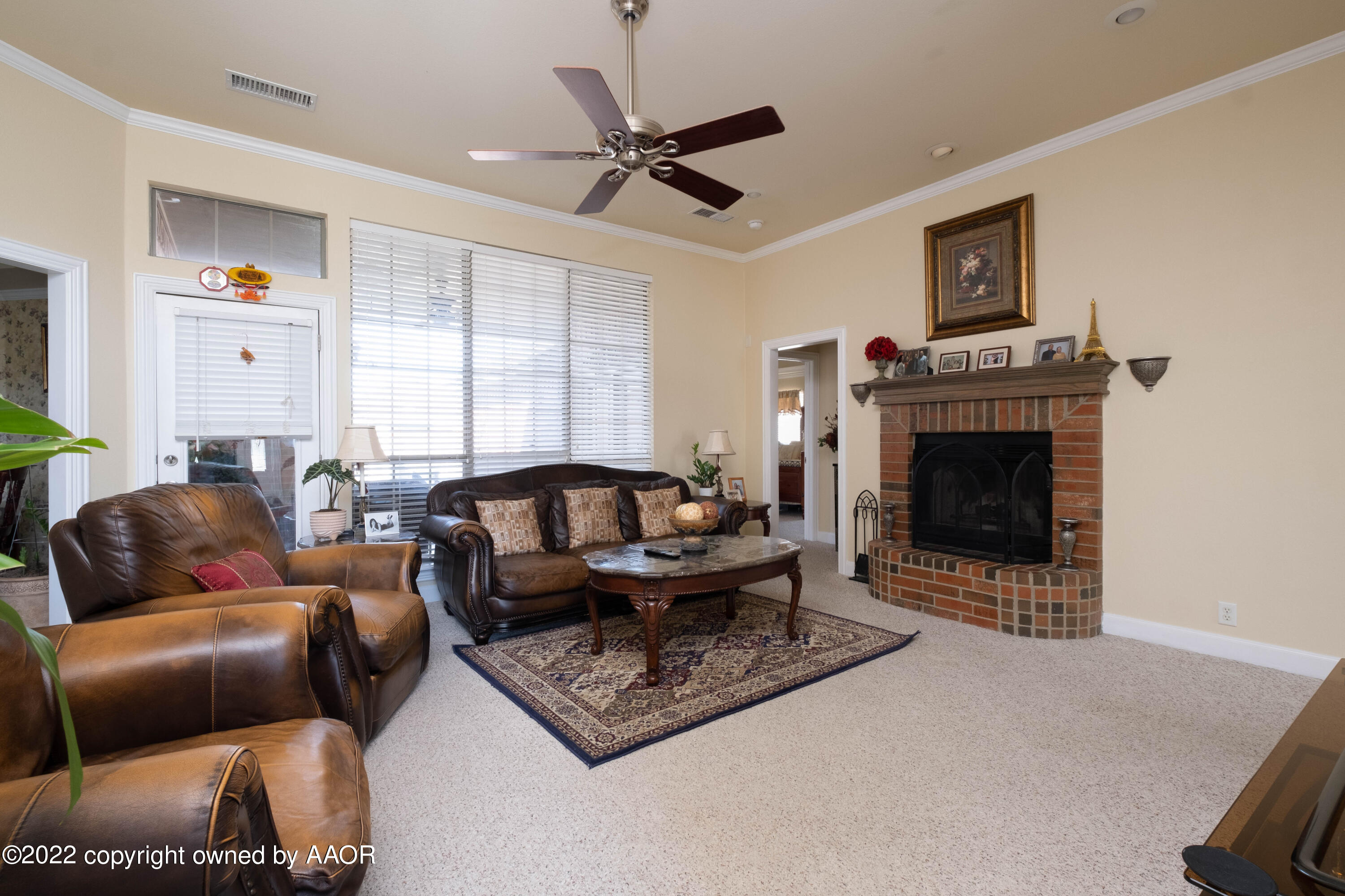 6607 Rally Road Amarillo, TX 79119 - Photo 5 of 34 a living room with furniture a fireplace and a window