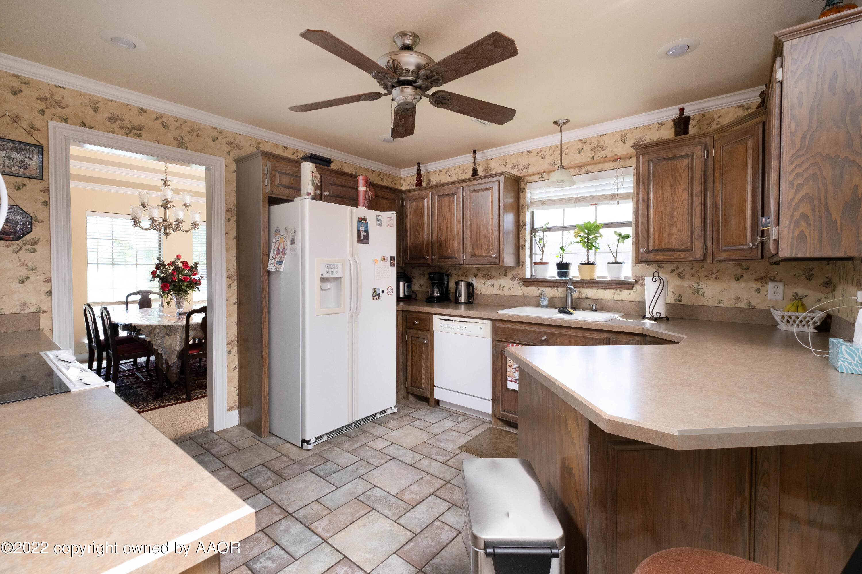 6607 Rally Road Amarillo, TX 79119 - Photo 10 of 34 a kitchen with a refrigerator a sink and dishwasher
