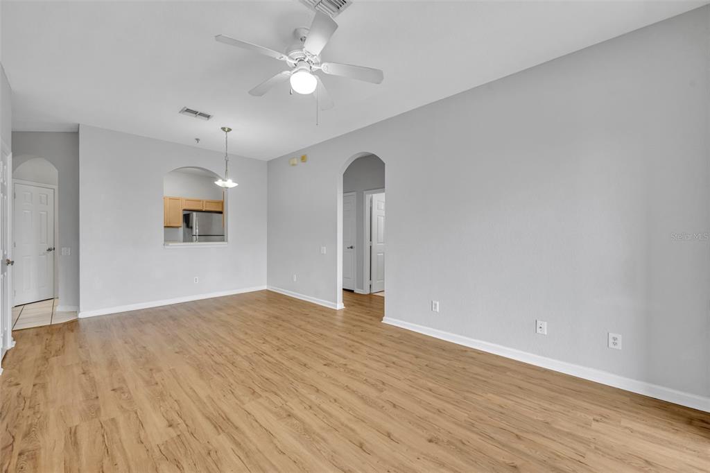 582 Brantley Terrace Way, Unit 304 Altamonte Springs, FL 32714 - Photo 12 of 30 an empty room with wooden floor and ceiling fan