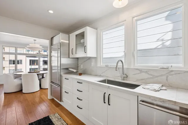 a kitchen with a sink stove and cabinets