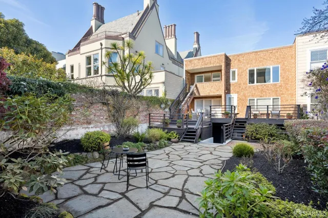 a view of a patio with couches table and chairs and potted plants
