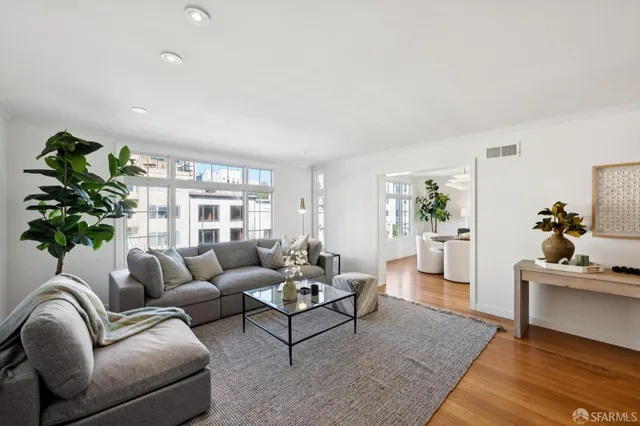 a living room with furniture and a potted plant