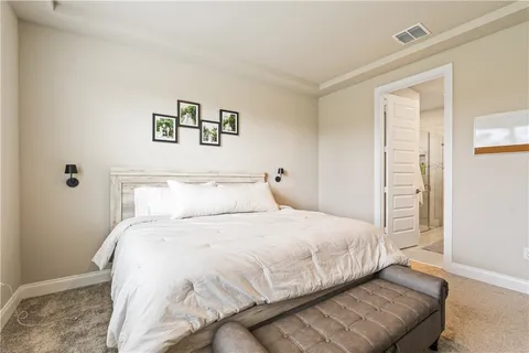 a bedroom with a bed and a couch