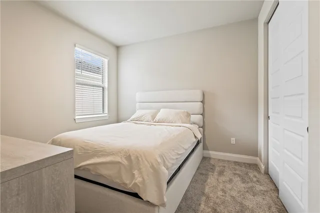 a bedroom with a bed and window