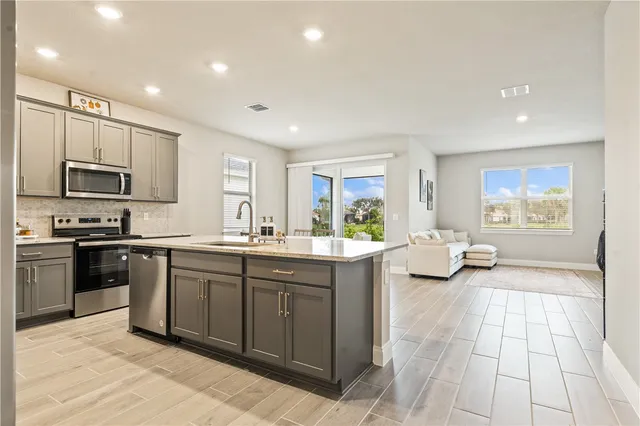 a large kitchen with stainless steel appliances lots of counter top space