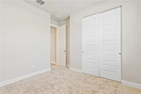 an empty room with closet area