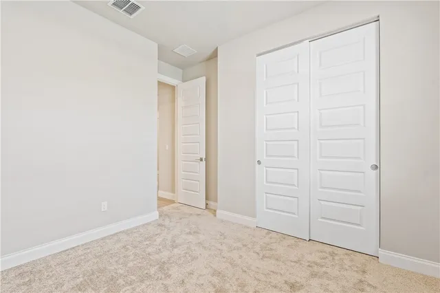 an empty room with closet area