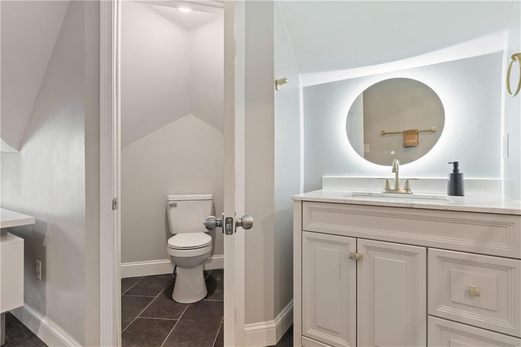 31 Harrison Street Pittsburgh, PA 15205 - Photo 15 of 32 a bathroom with a toilet a sink and mirror