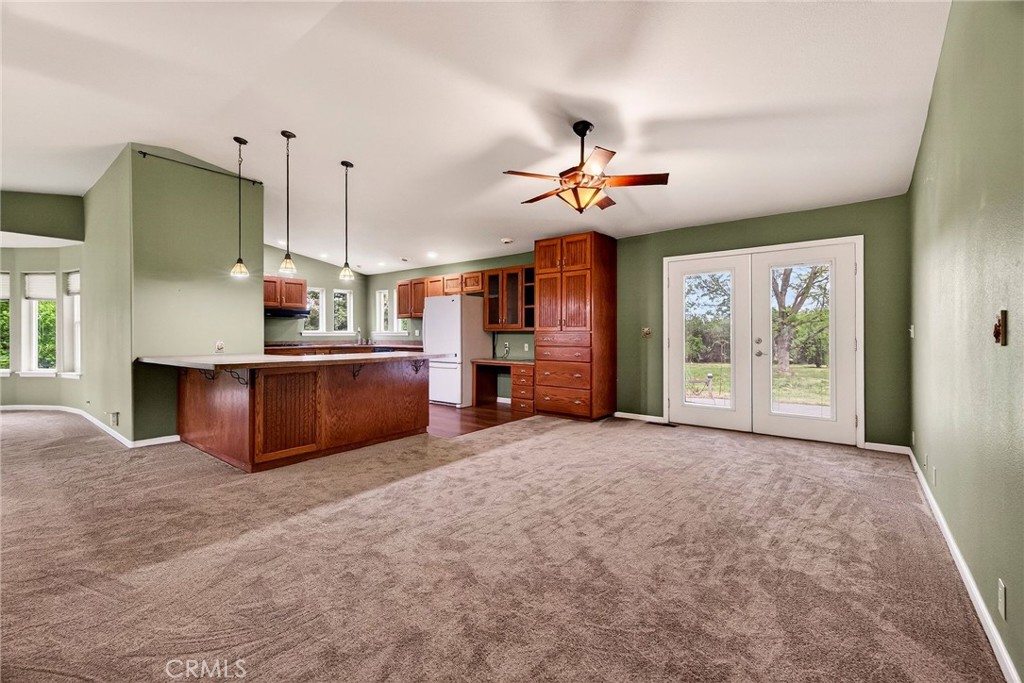 3770 Hall Road Corning, CA 96021 - Photo 12 of 64 a view of a kitchen with a flat screen tv and a fireplace
