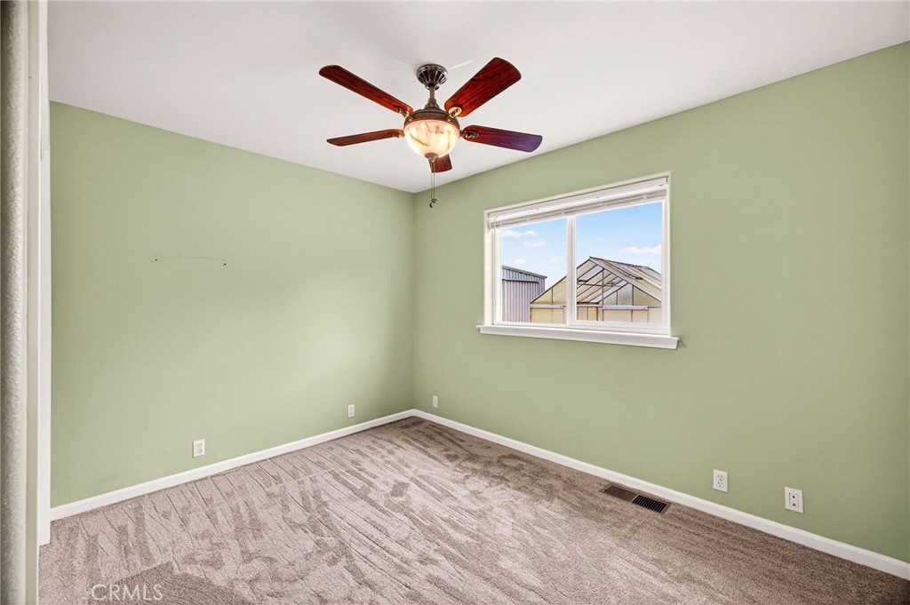 3770 Hall Road Corning, CA 96021 - Photo 26 of 64 an empty room with wooden floor and ceiling fan