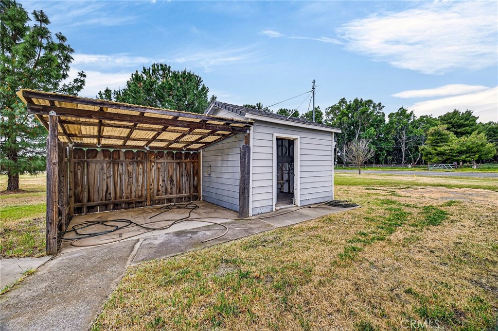 3770 Hall Road Corning, CA 96021 - Photo 49 of 64 a view of a backyard with barn and wooden fence