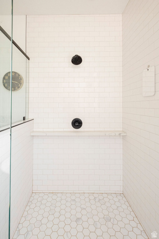 924 Country Lane Farmington, UT 84025 - Photo 31 of 91 Shower stall featuring white subway tile walls, hexagonal floor tiles, and a built-in shelf