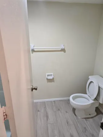 a white toilet sitting next to a bathroom sink