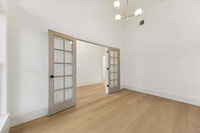 an empty room with windows and closet