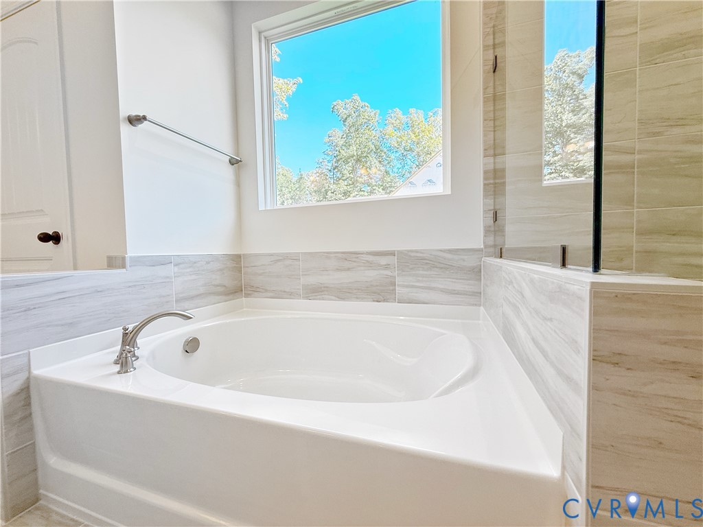 8130 Clancy Court Chesterfield, VA 23838 - Photo 16 of 36 The first-floor primary suite boasts a large walk-