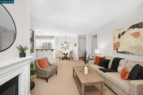 a view of kitchen with furniture and refrigerator