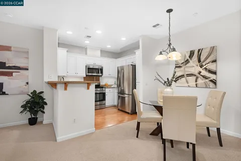 a kitchen with stainless steel appliances granite countertop a refrigerator sink and stove