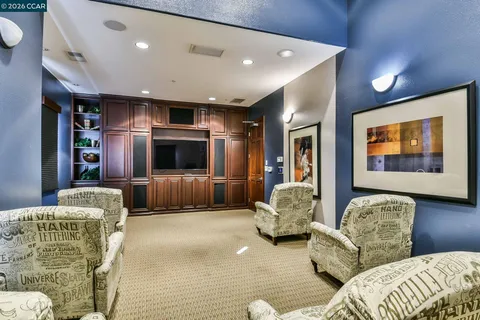 a view of a swimming pool with a bench and trees in the background