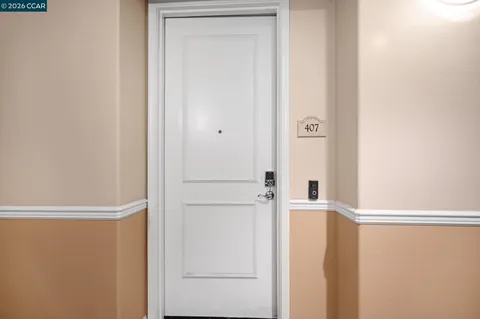 a dining room with stainless steel appliances kitchen island granite countertop furniture and a refrigerator