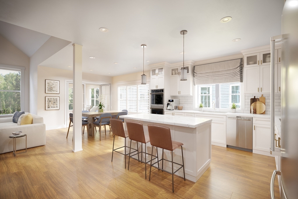 a kitchen with white cabinets and chairs