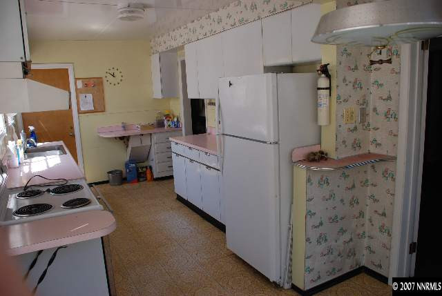 210 Wonder Street Reno, NV 89502 - Photo 2 of 7 a room with a refrigerator and a dresser