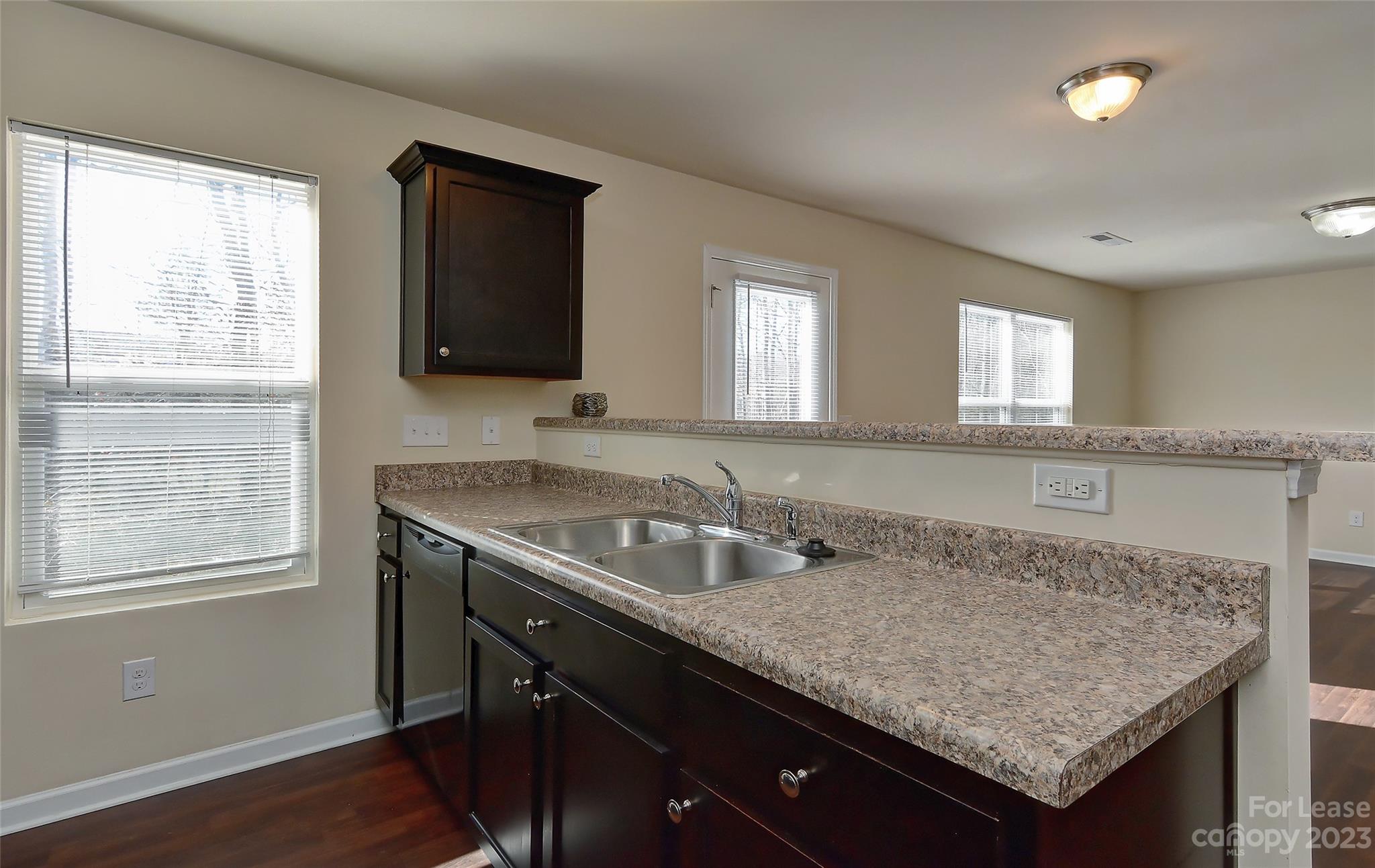 2010 Turtle Point Road Charlotte, NC 28262 - Photo 12 of 39 a bathroom with a granite countertop sink a mirror and wooden cabinets