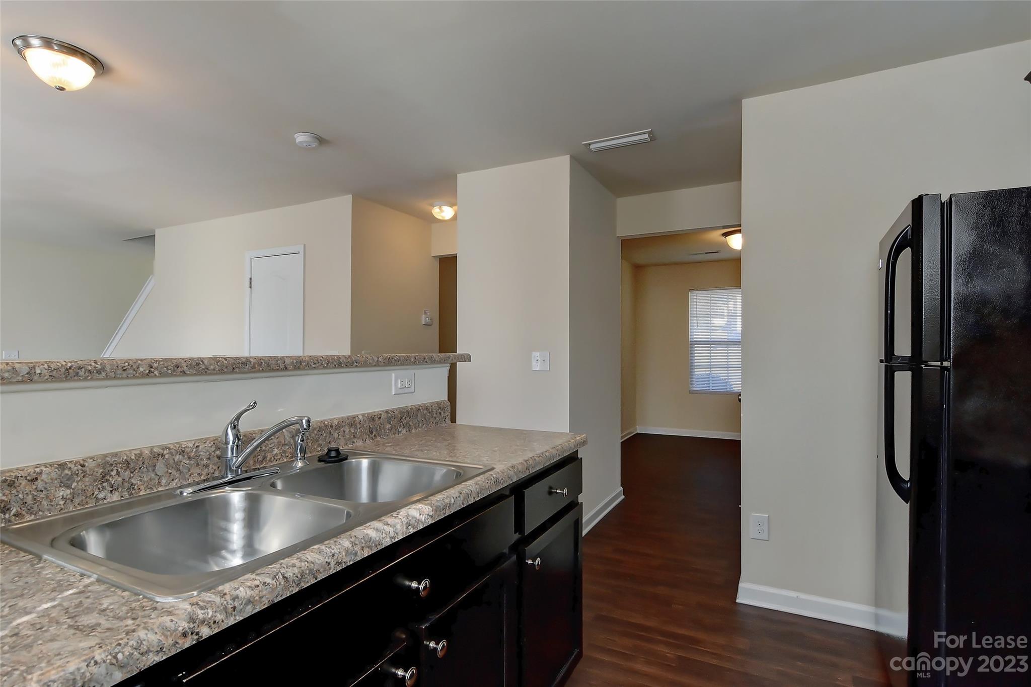 2010 Turtle Point Road Charlotte, NC 28262 - Photo 14 of 39 a kitchen with granite countertop a sink and refrigerator