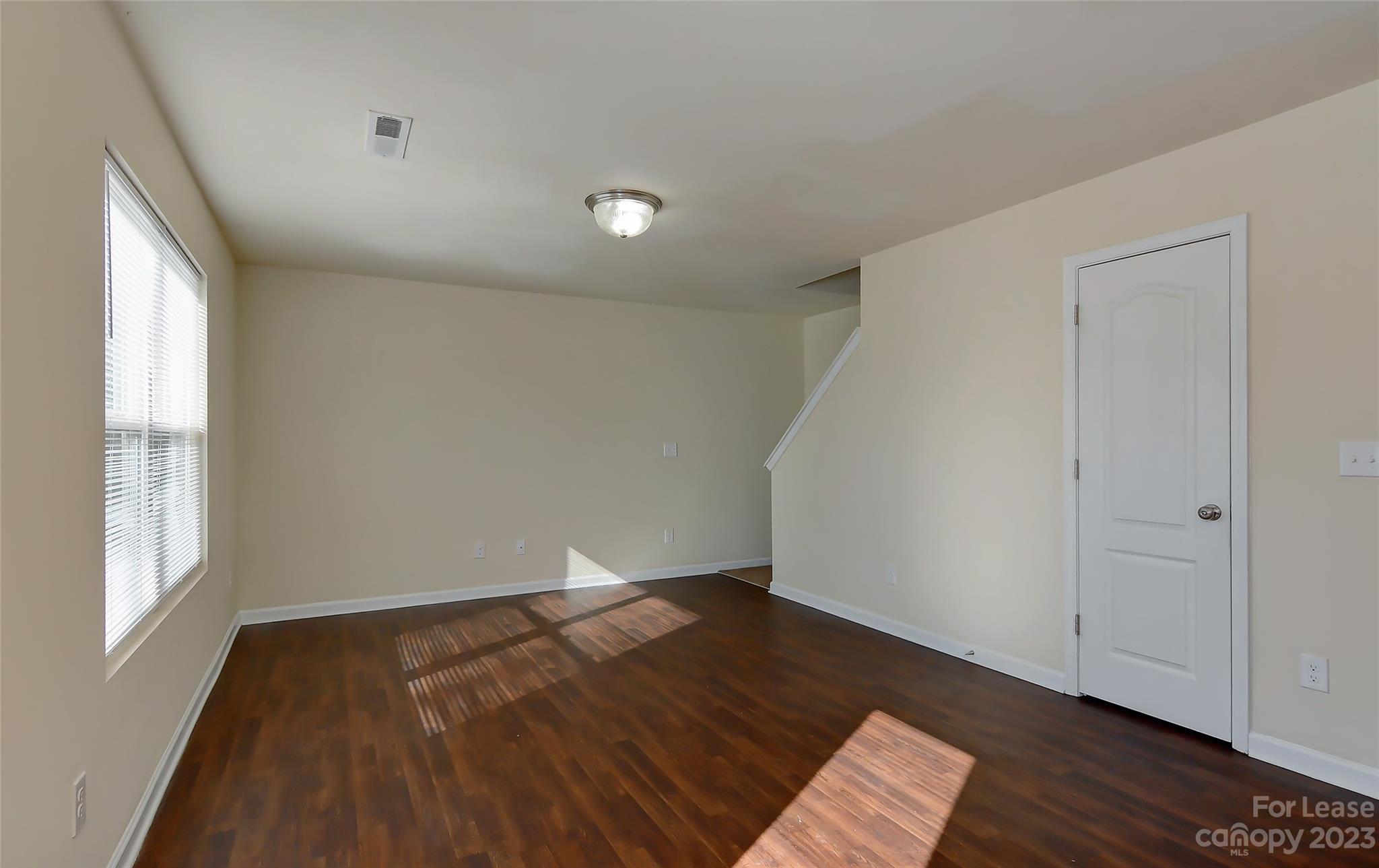 2010 Turtle Point Road Charlotte, NC 28262 - Photo 17 of 39 an empty room with wooden floor and windows