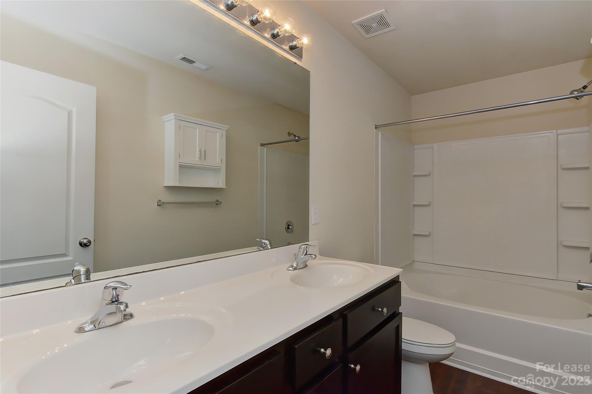 2010 Turtle Point Road Charlotte, NC 28262 - Photo 25 of 39 a bathroom with a granite countertop sink a toilet and shower