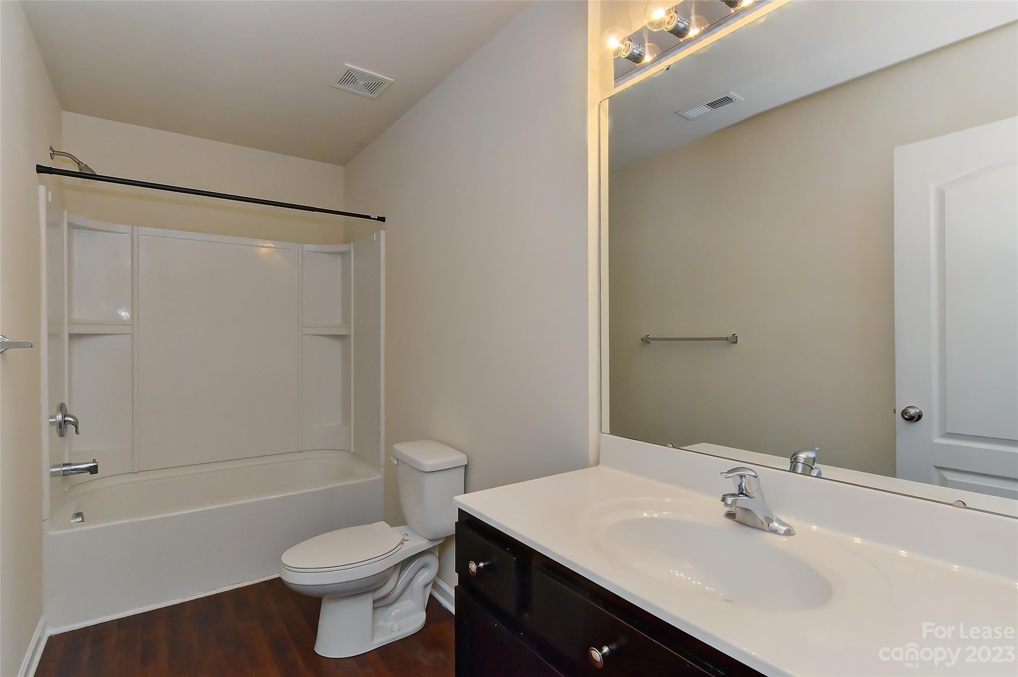 2010 Turtle Point Road Charlotte, NC 28262 - Photo 33 of 39 a bathroom with a sink toilet vanity and shower