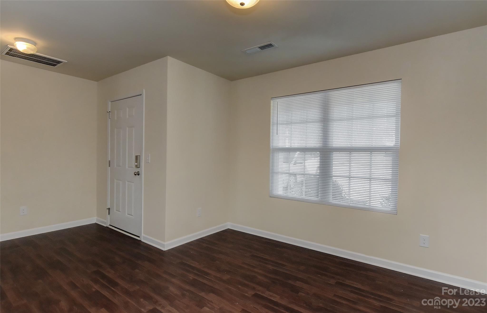 2010 Turtle Point Road Charlotte, NC 28262 - Photo 9 of 39 an empty room with wooden floor and windows