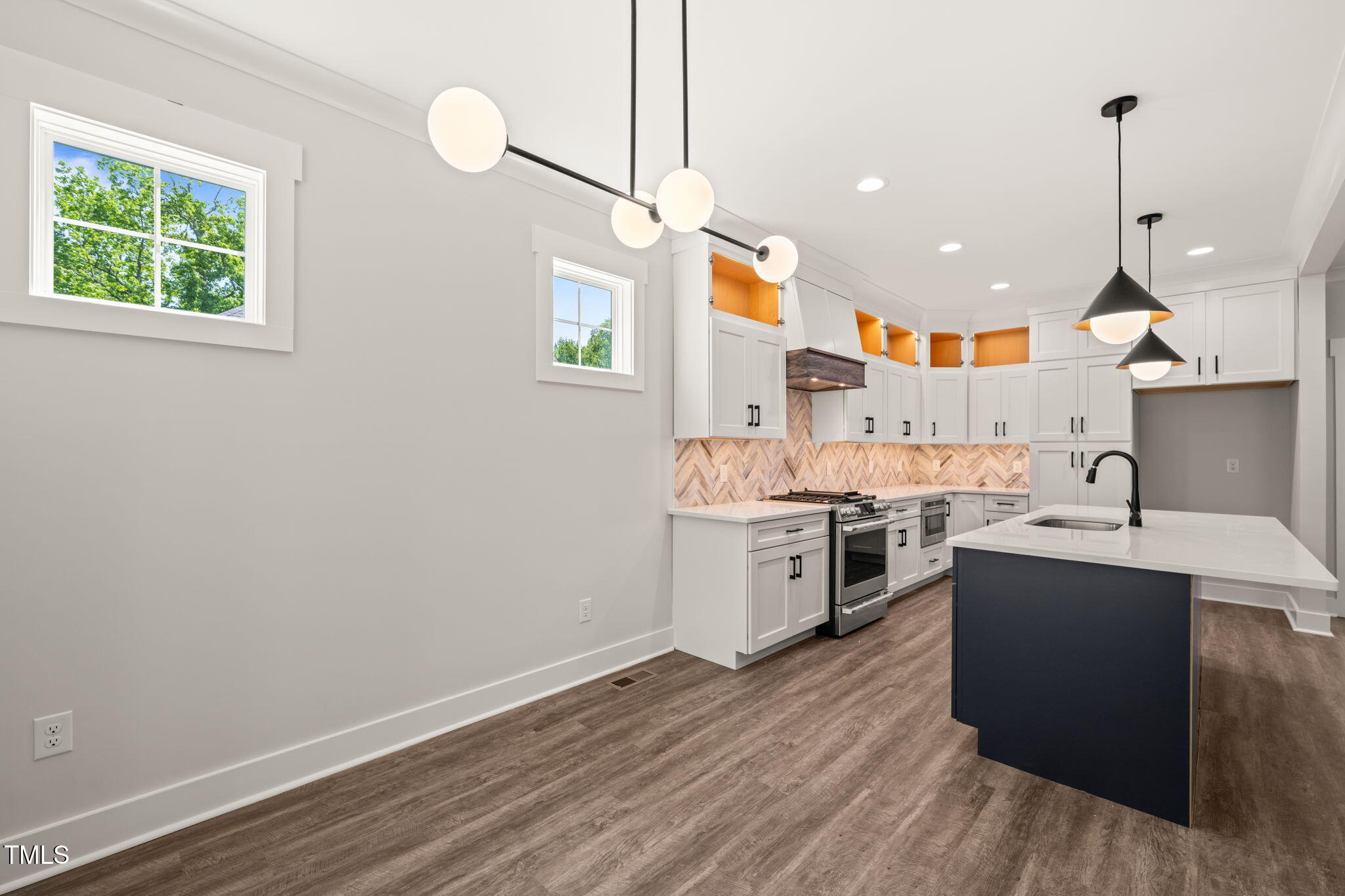 320 Pilot Ridge Road Zebulon, NC 27597 - Photo 11 of 49 a kitchen with stainless steel appliances granite countertop a sink stove and refrigerator