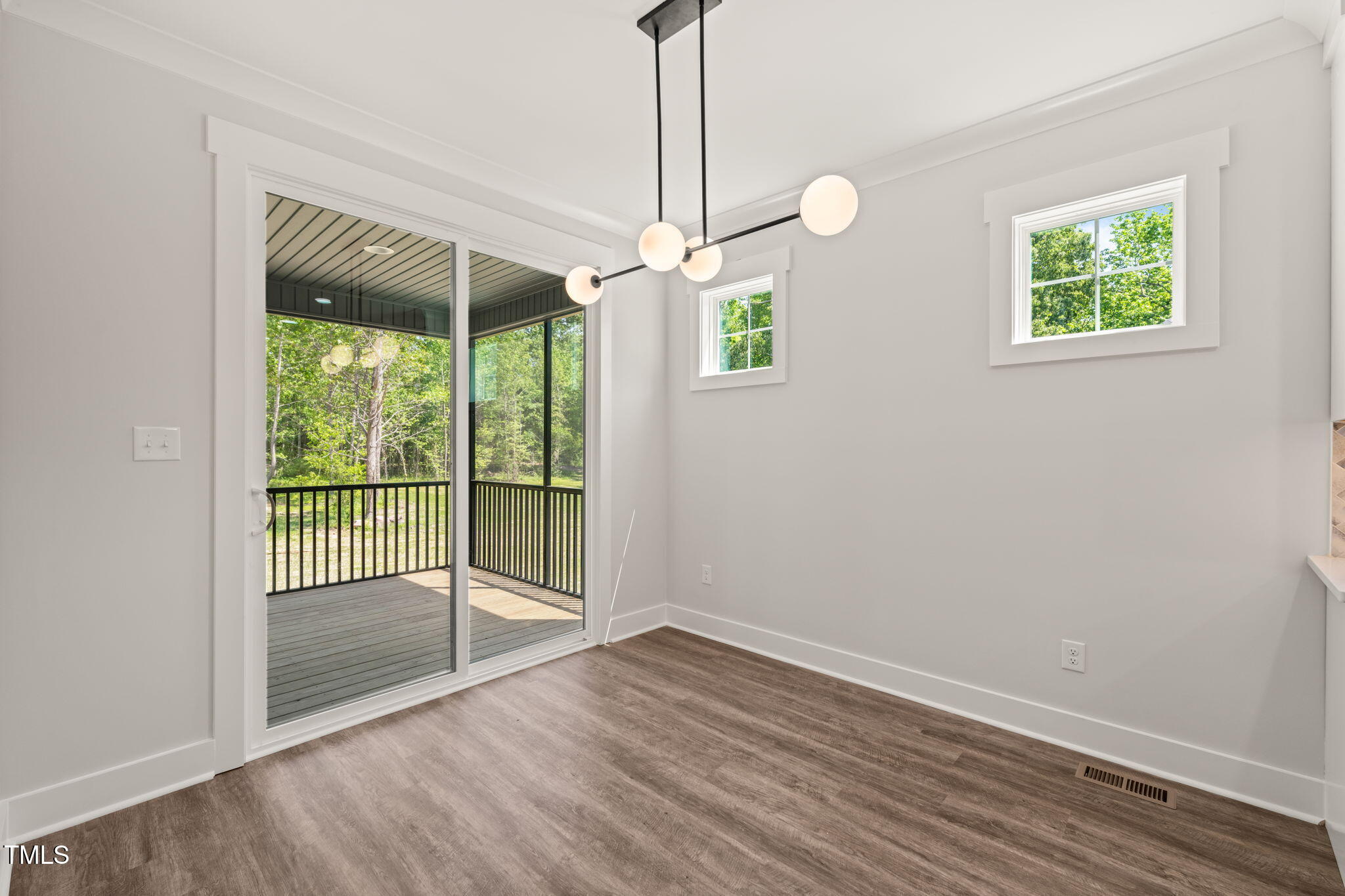 320 Pilot Ridge Road Zebulon, NC 27597 - Photo 12 of 49 en empty room with wooden floor and windows