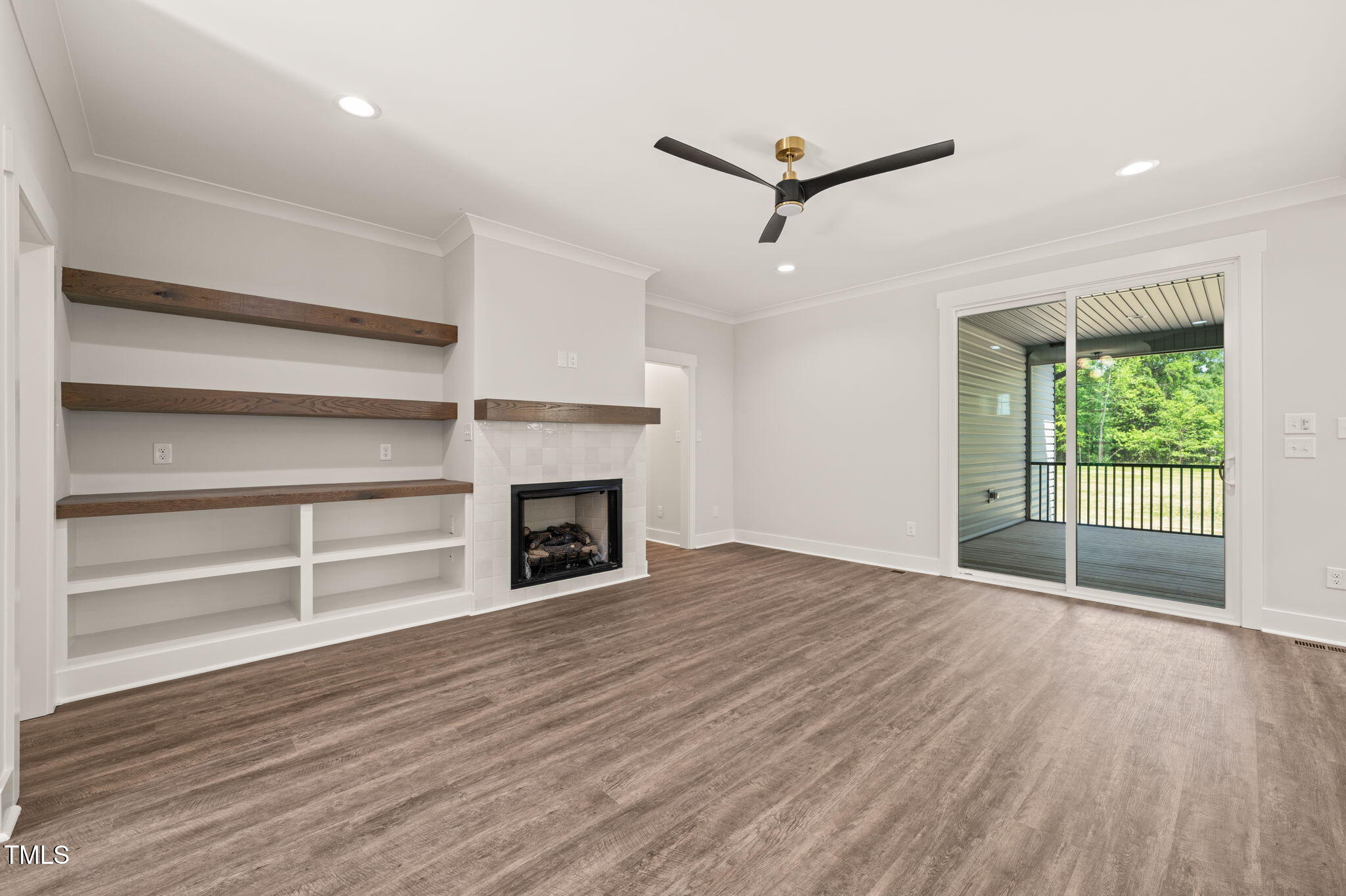 320 Pilot Ridge Road Zebulon, NC 27597 - Photo 15 of 49 a view of a livingroom with wooden floor a fireplace and windows