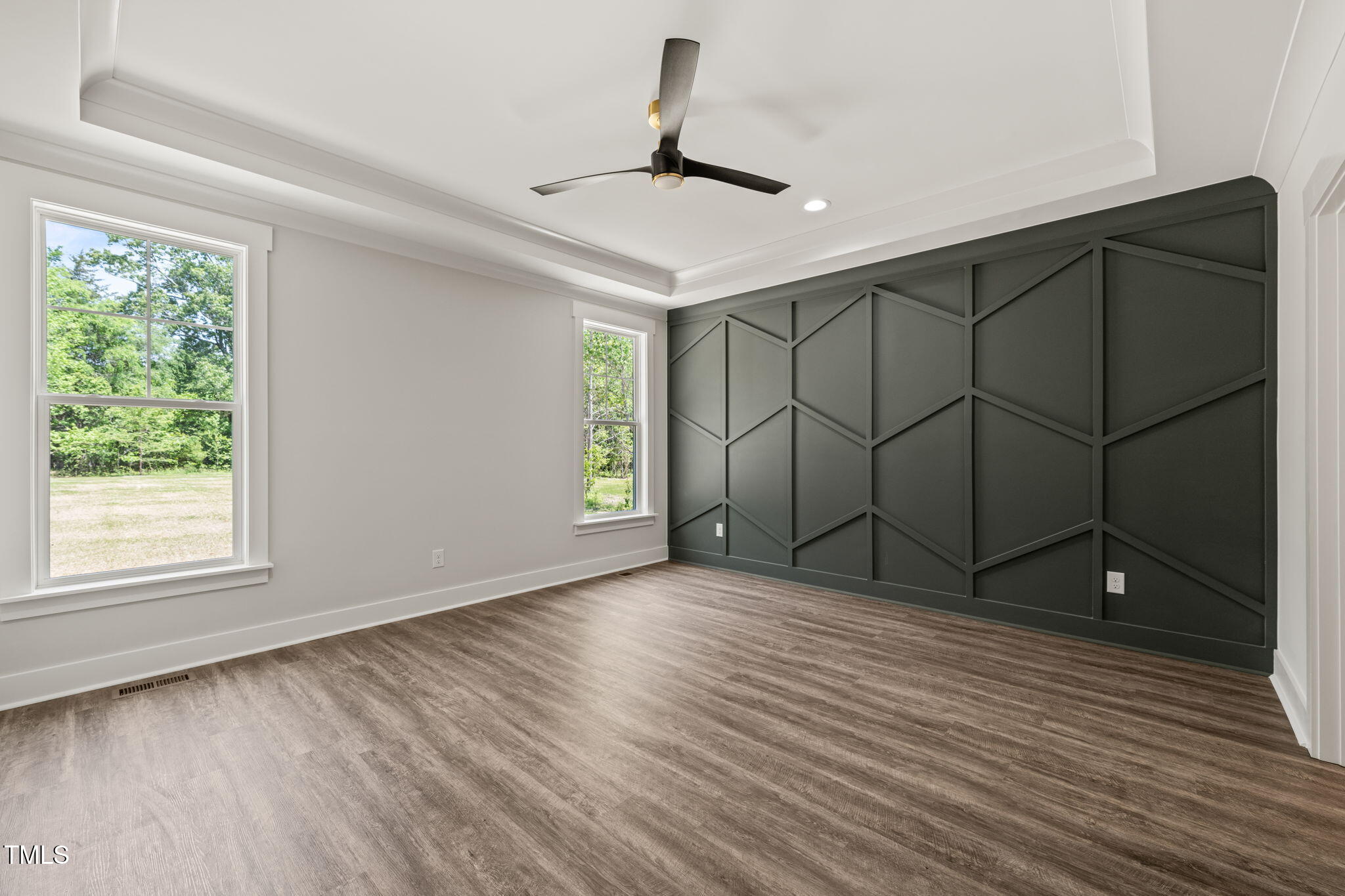 320 Pilot Ridge Road Zebulon, NC 27597 - Photo 20 of 49 an empty room with wooden floor cabinet and windows