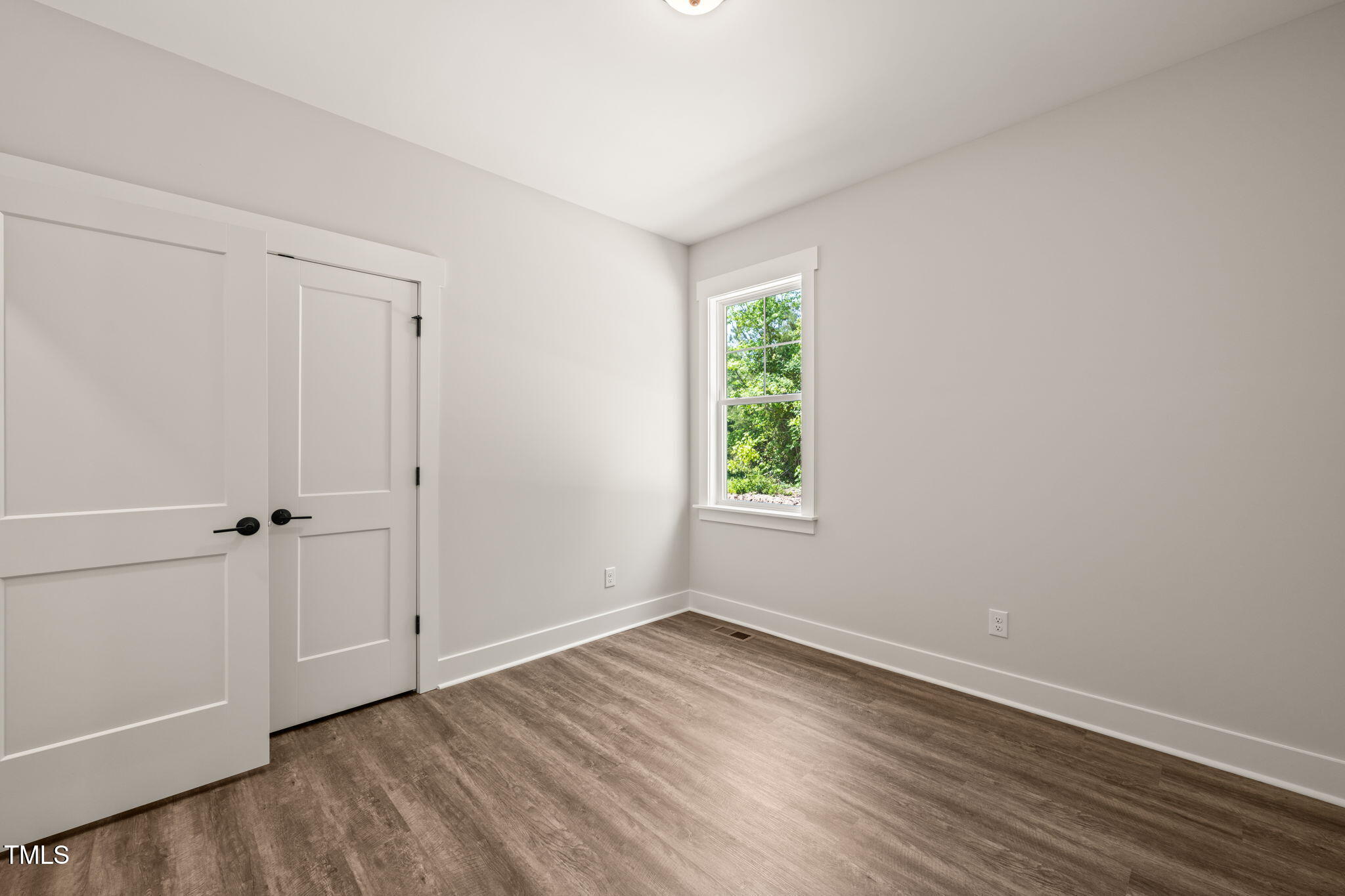 320 Pilot Ridge Road Zebulon, NC 27597 - Photo 27 of 49 a view of an empty room with wooden floor and a window