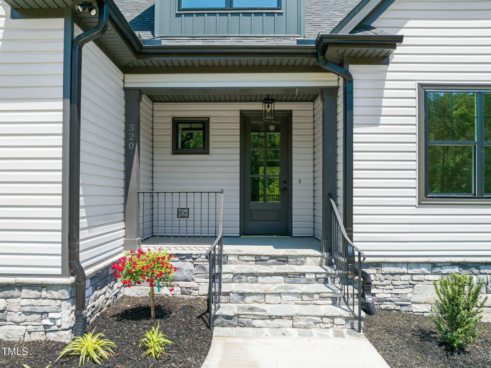 320 Pilot Ridge Road Zebulon, NC 27597 - Photo 4 of 49 a front view of a house with a garden