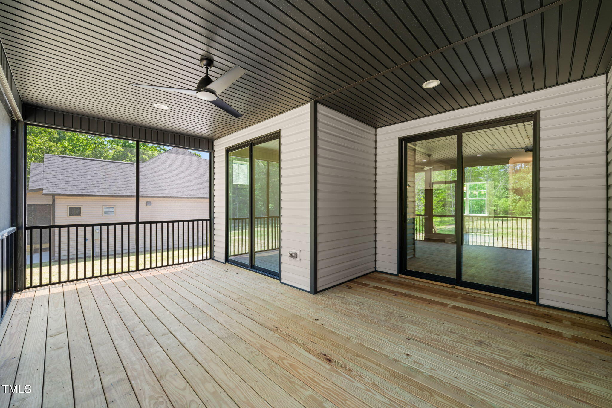 320 Pilot Ridge Road Zebulon, NC 27597 - Photo 41 of 49 a view of backyard with large windows and wooden floor