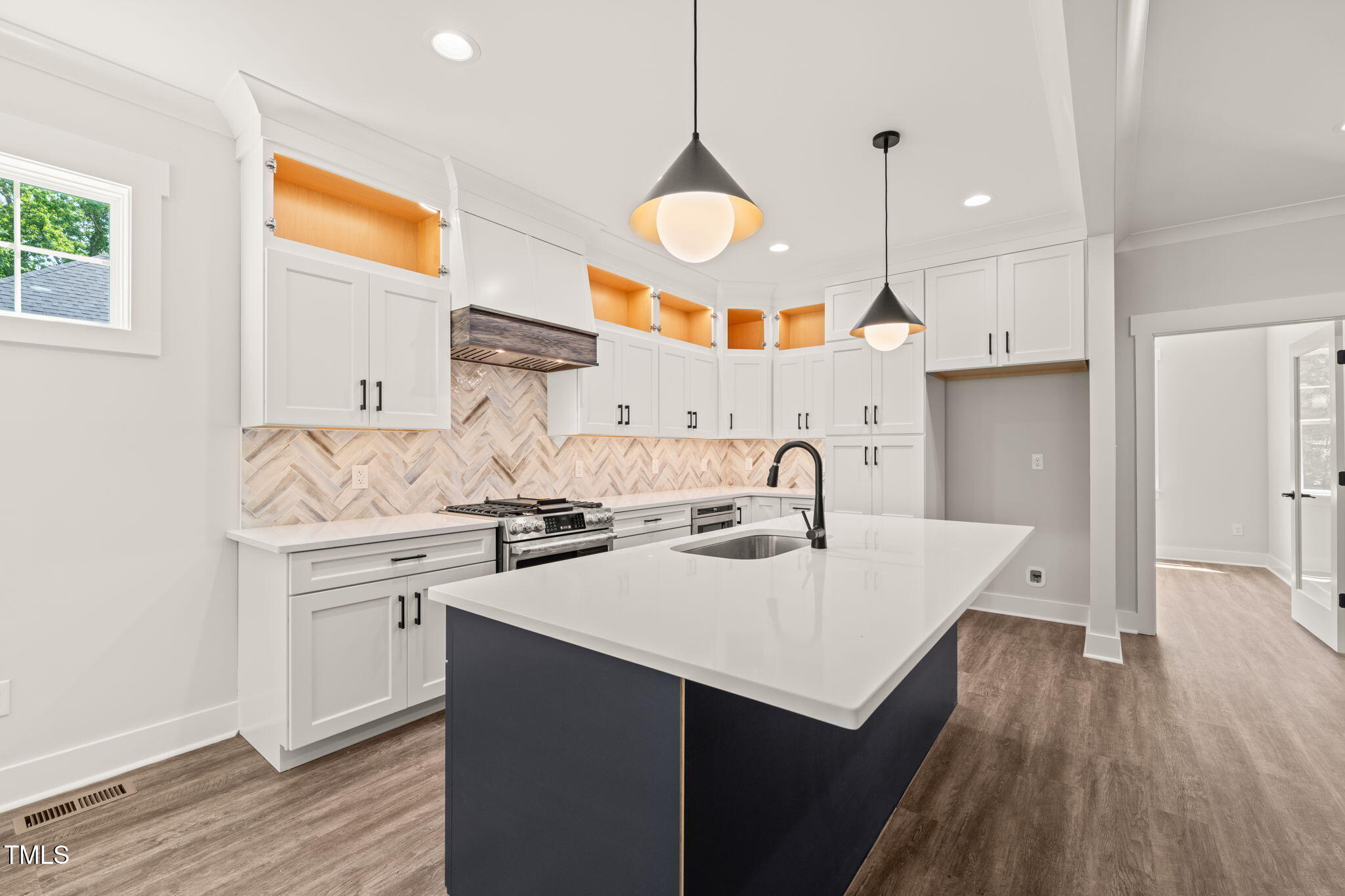 320 Pilot Ridge Road Zebulon, NC 27597 - Photo 8 of 49 a kitchen with a sink a stove cabinets and wooden floor