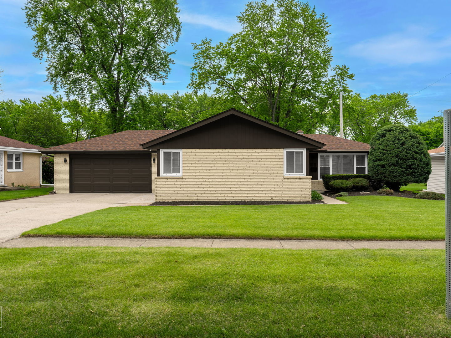 a front view of house with yard and green space