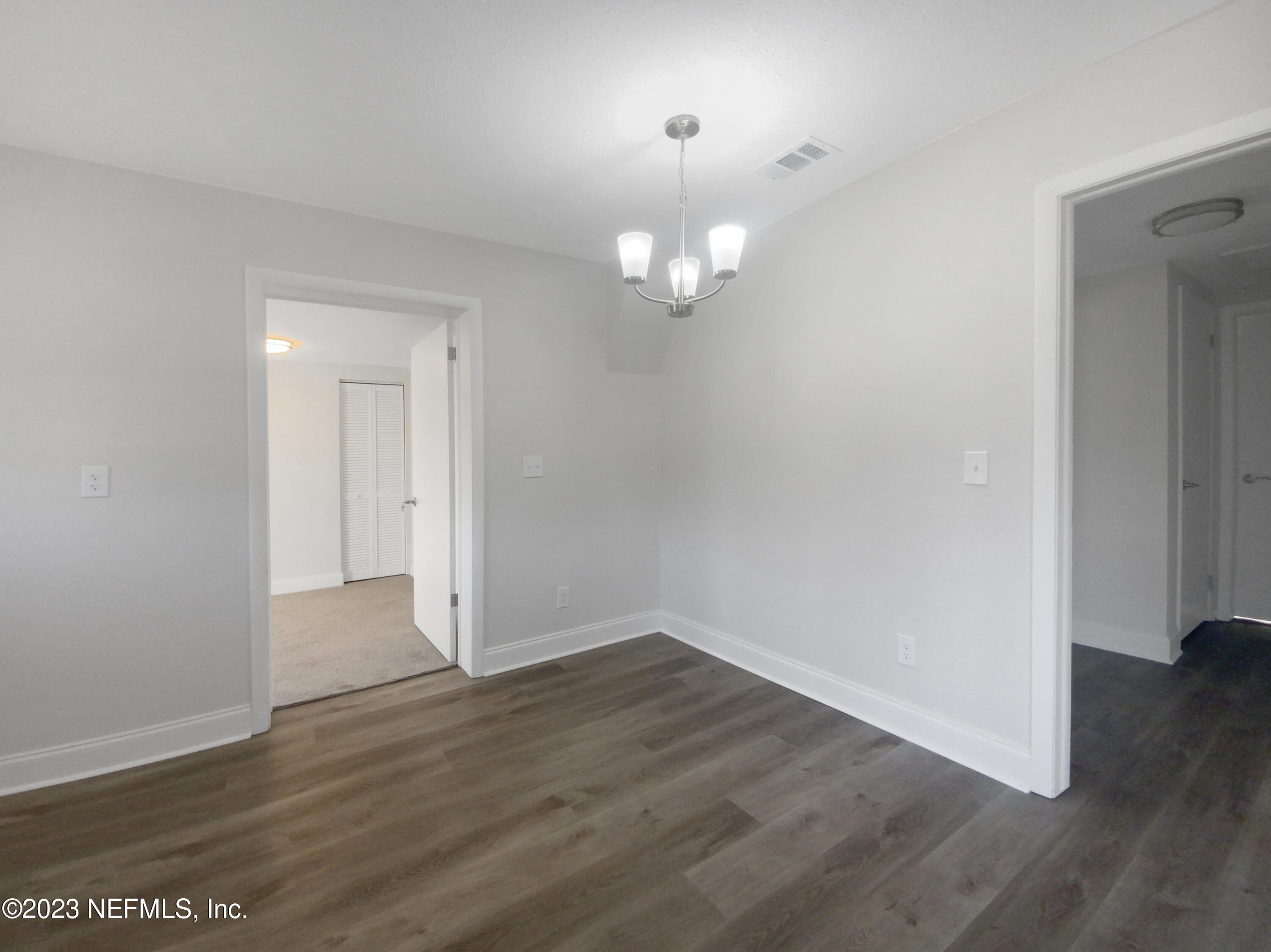 4204 Clyde Drive Jacksonville, FL 32208 - Photo 13 of 20 an empty room with wooden floor and windows