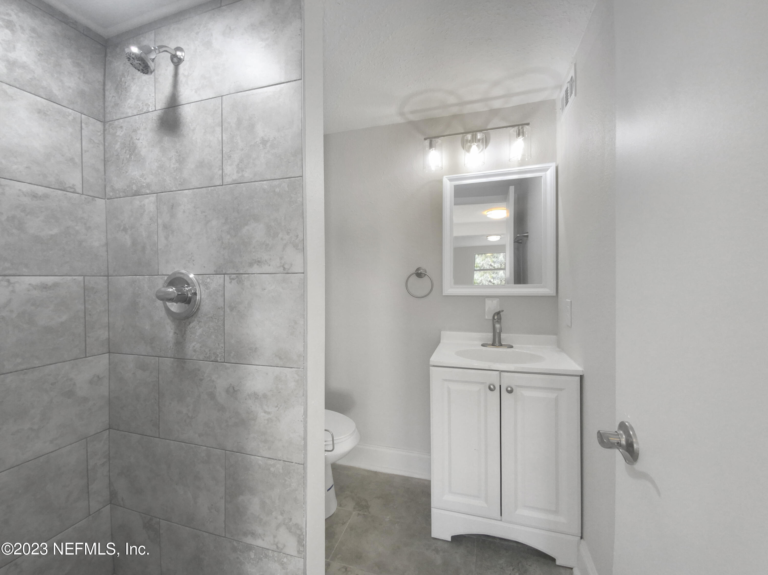 4204 Clyde Drive Jacksonville, FL 32208 - Photo 16 of 20 a bathroom with a sink a toilet and mirror
