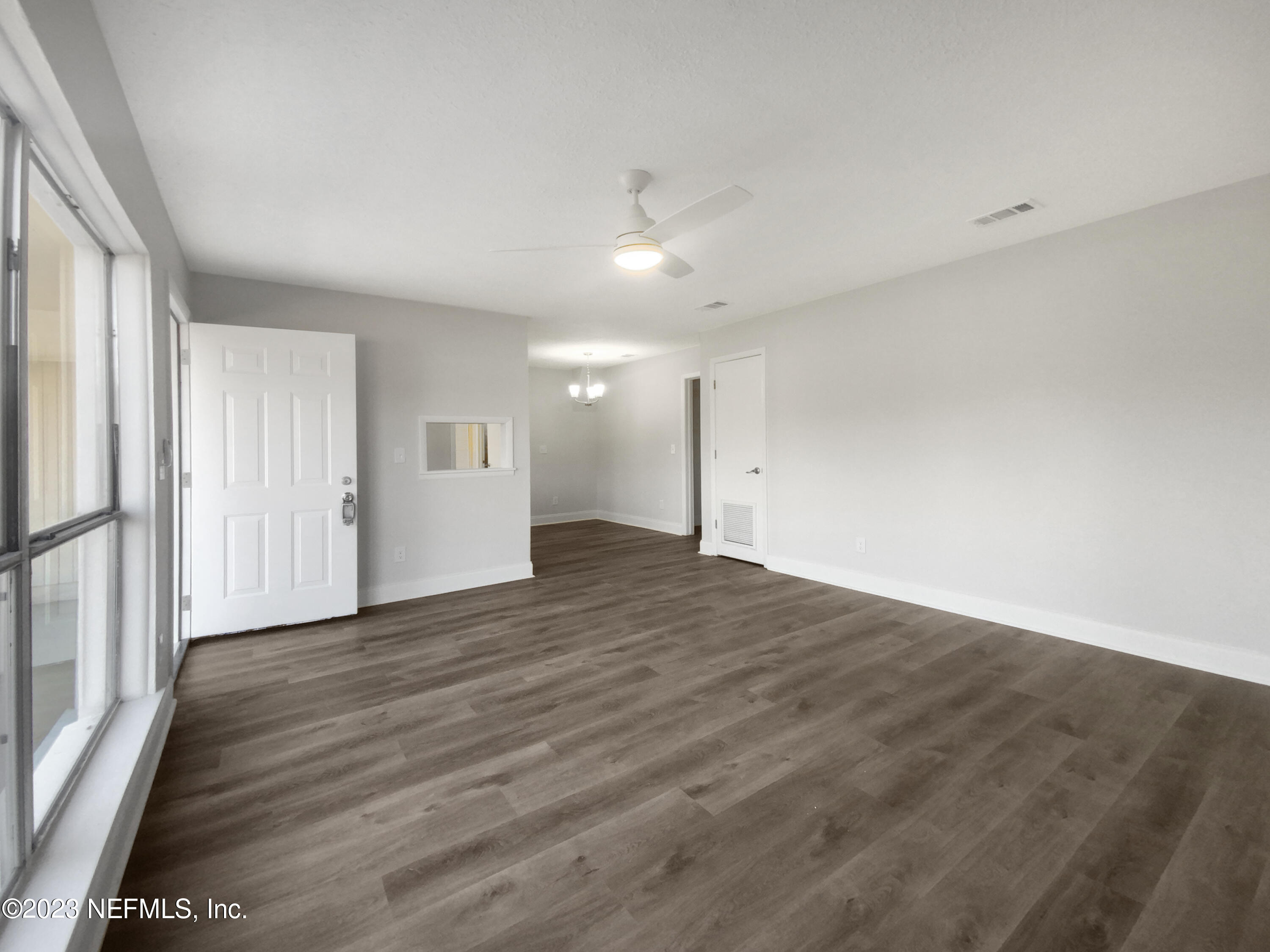 4204 Clyde Drive Jacksonville, FL 32208 - Photo 3 of 20 a view of empty room with wooden floor and window