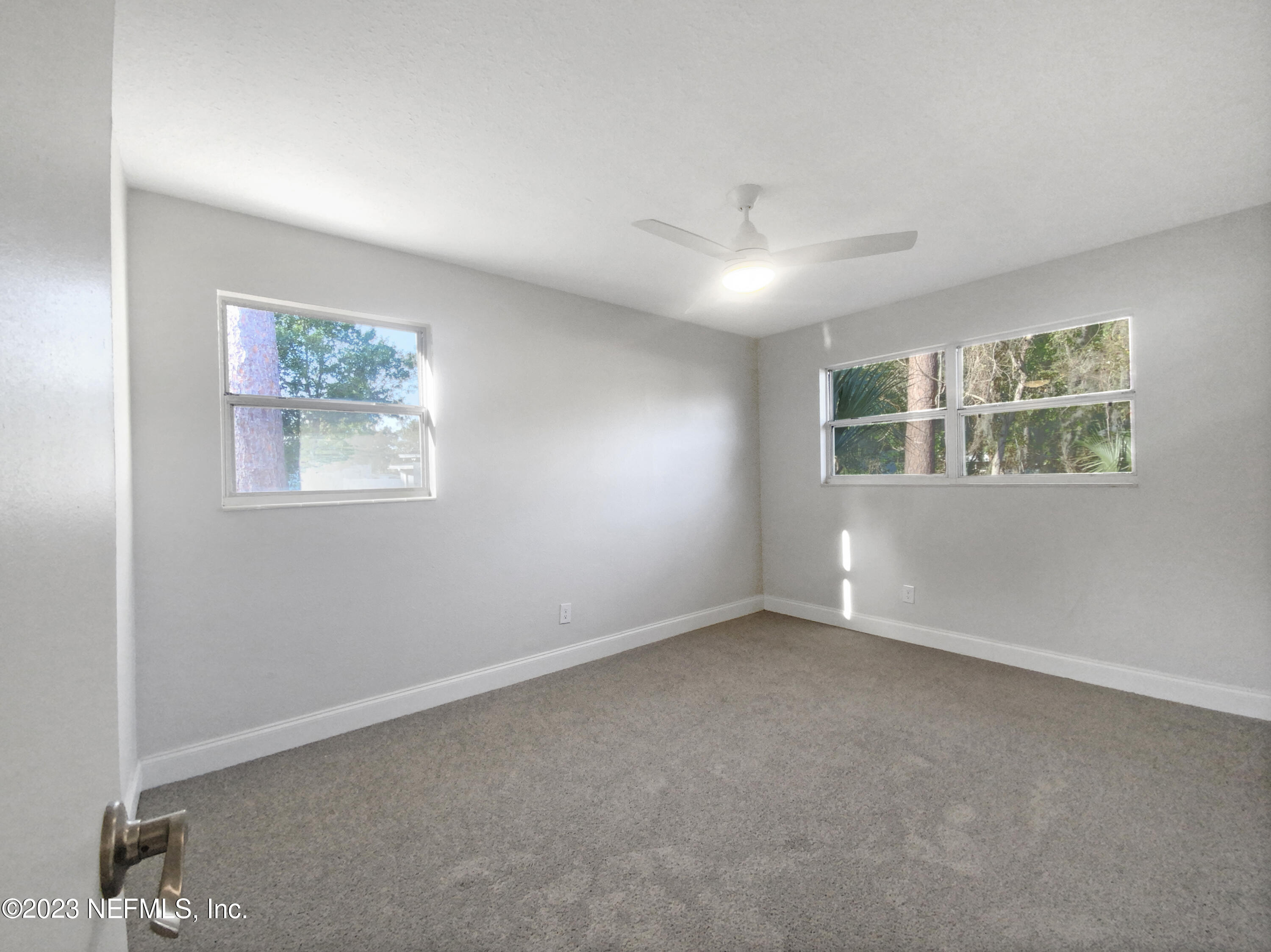 4204 Clyde Drive Jacksonville, FL 32208 - Photo 5 of 20 an empty room with windows and fan