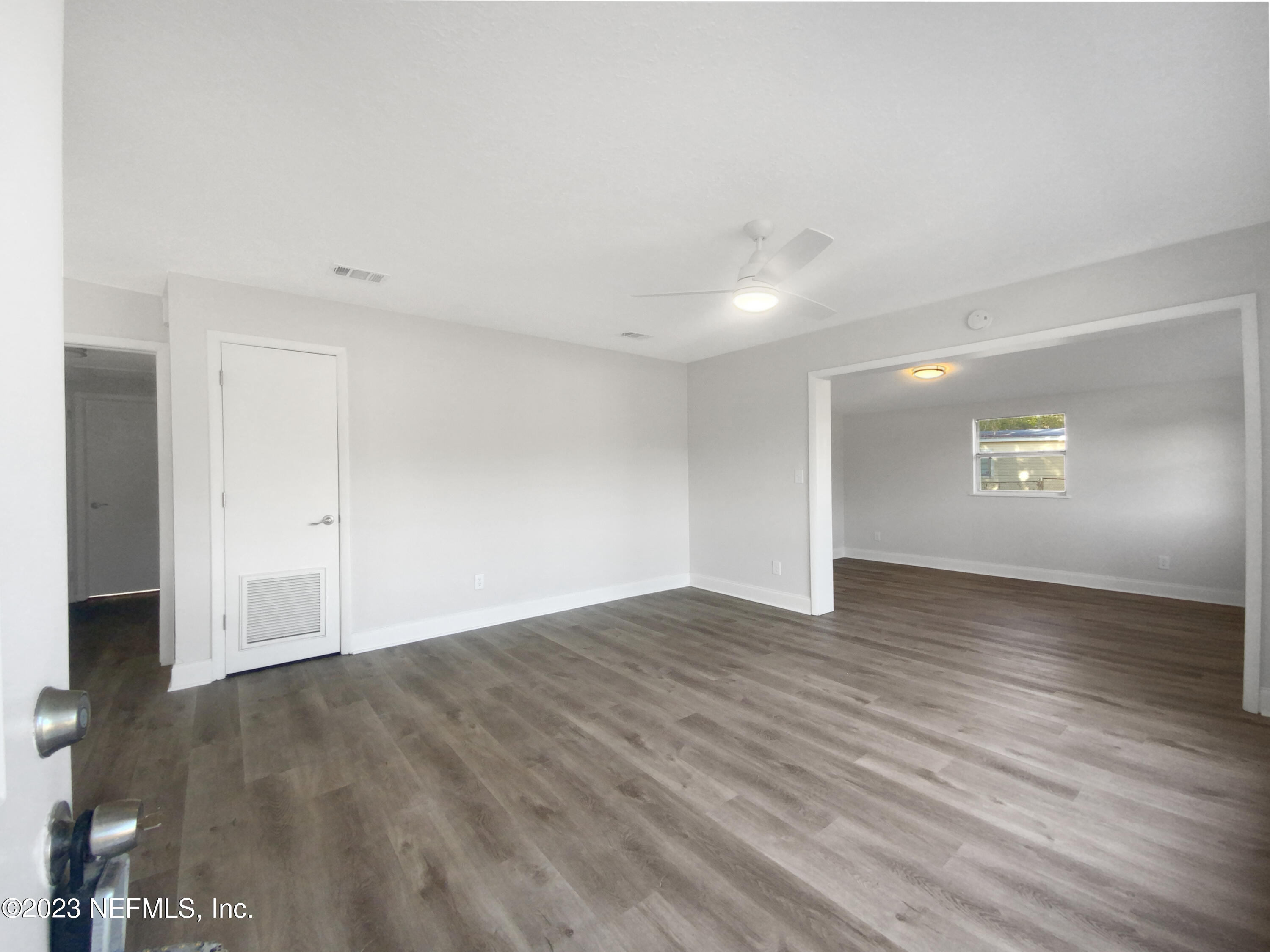 4204 Clyde Drive Jacksonville, FL 32208 - Photo 10 of 20 an empty room with wooden floor door and windows
