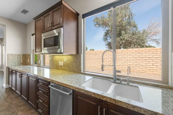 a utility room with sink dryer and washer