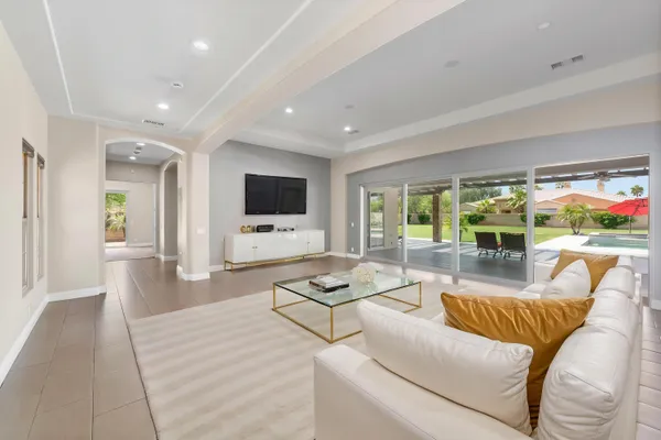 a kitchen with granite countertop sink and chairs
