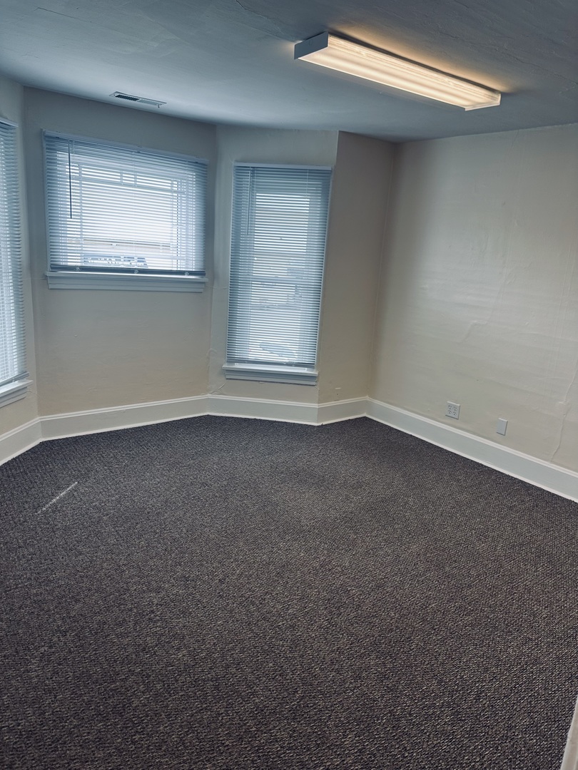 445 North Main Street, Unit 2 Sycamore, IL 60178 - Photo 5 of 11 an empty room with a empty space and windows